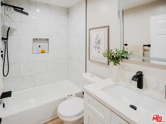 a bathroom with a sink a toilet and a tub