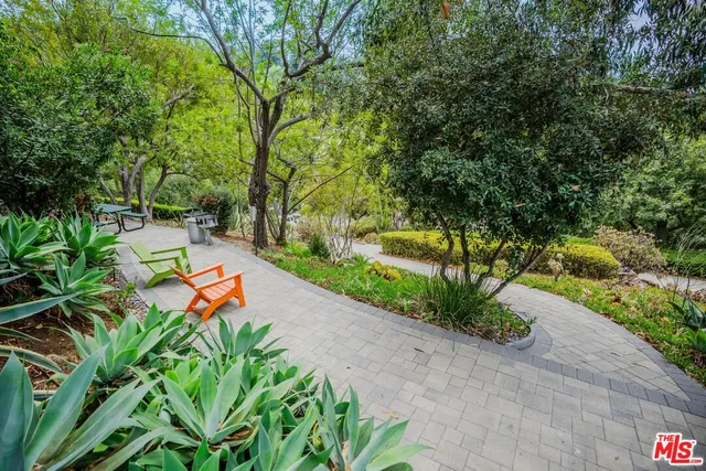 a backyard of a house with a yard and outdoor seating