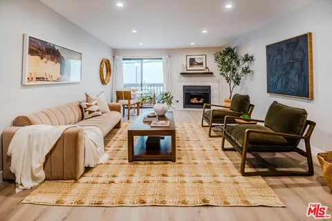 a living room with furniture a rug and a fireplace