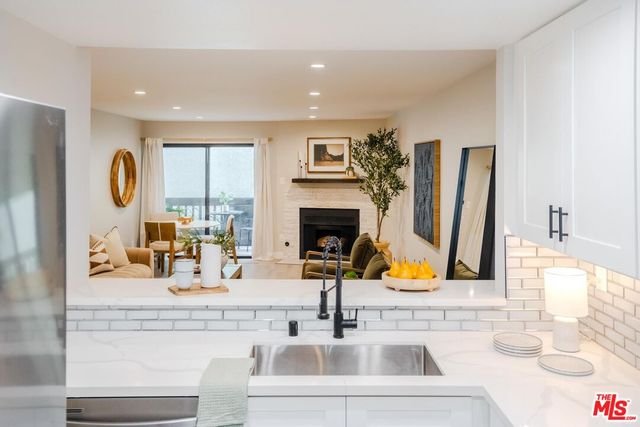 a bathroom with double vanity sink and a mirror