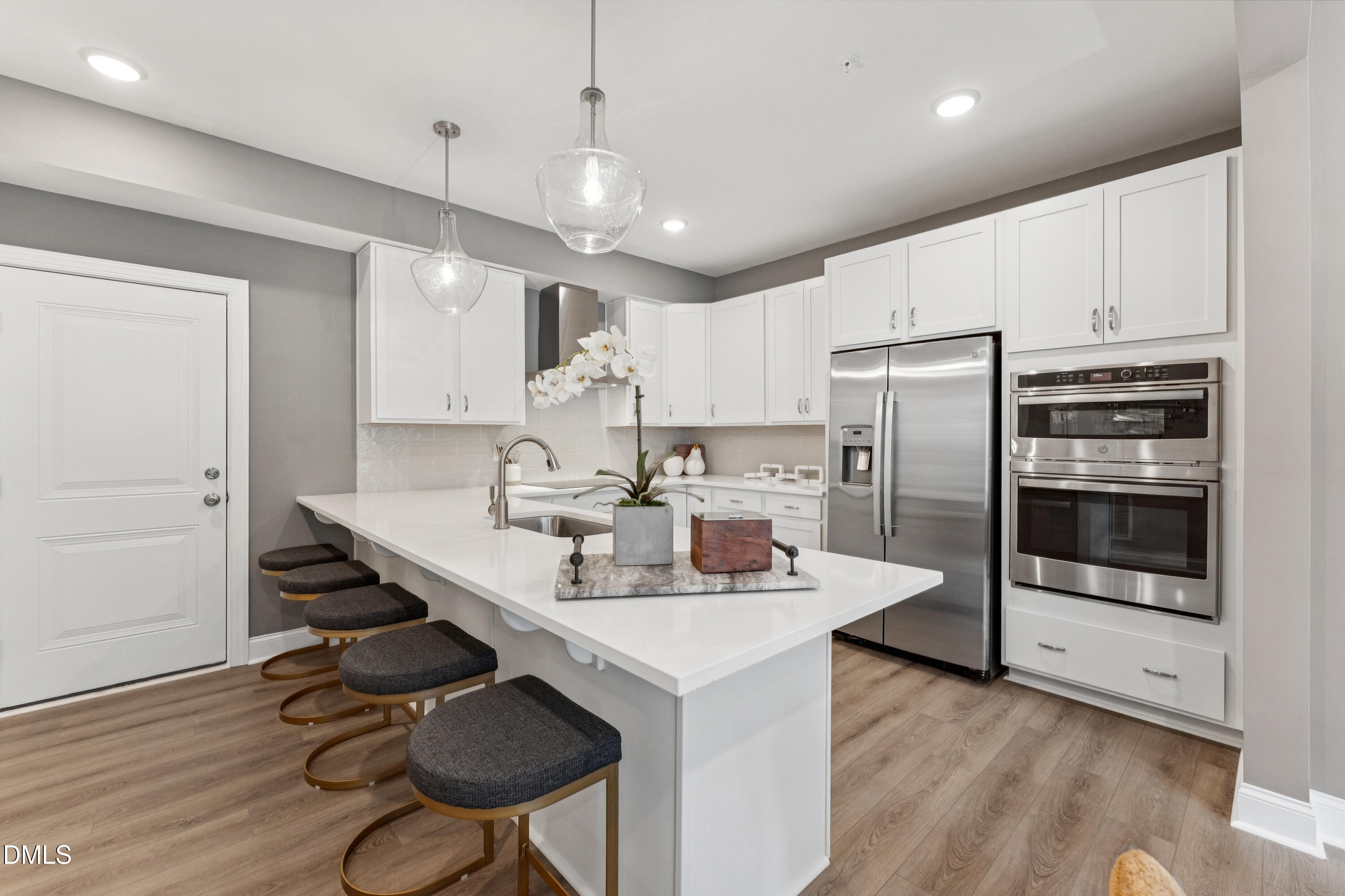 620 Hedrick Rdg Road, Unit 114 Cary, NC 27519 - Photo 4 of 29 a kitchen with stainless steel appliances a sink a stove a refrigerator cabinets and wooden floor