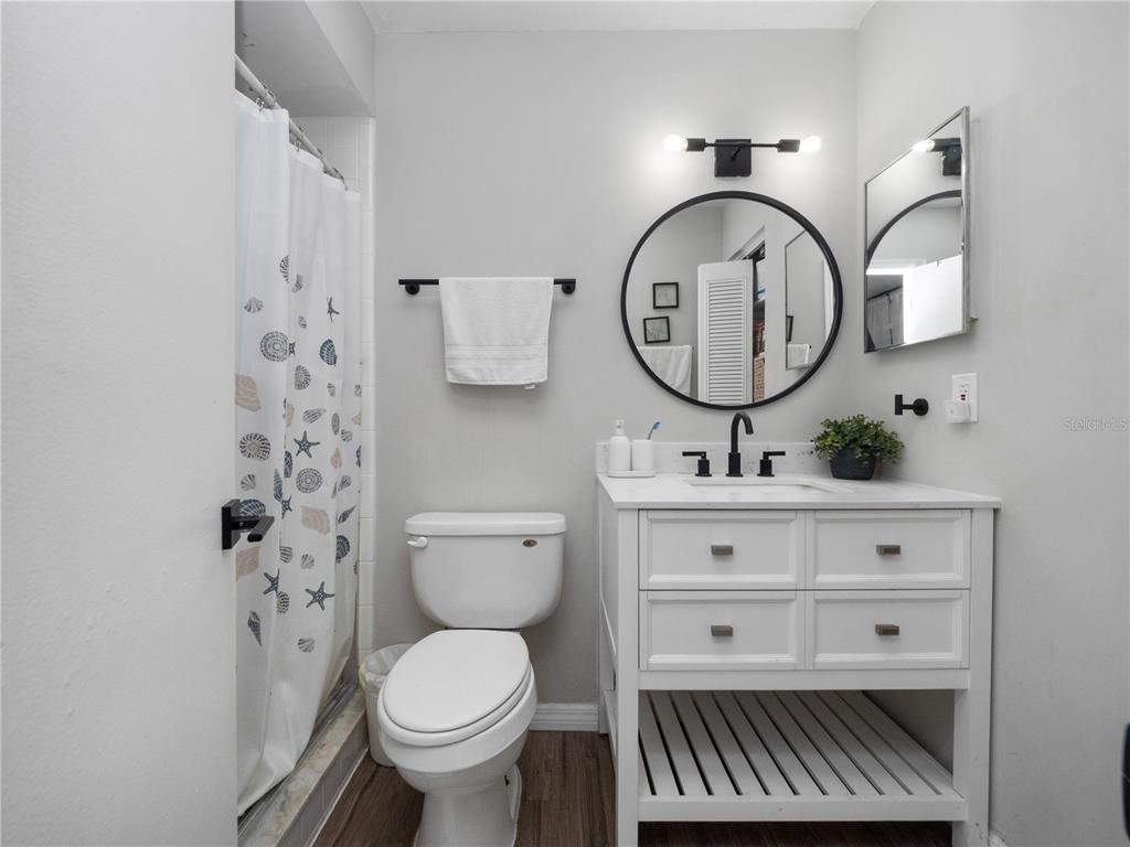 2733 Middle Street Orlando, FL 32807 - Photo 18 of 23 a bathroom with a toilet a sink and a mirror