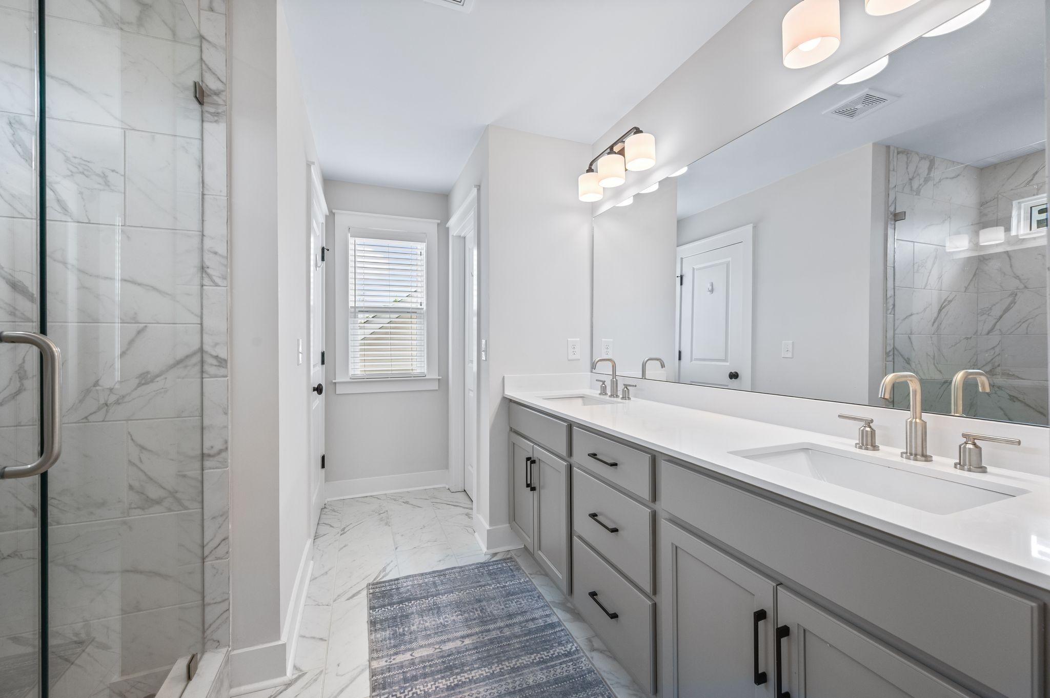 141 Foxhall Dr Spring Hill Spring Hill, TN 37174 - Photo 13 of 31 a bathroom with a double vanity sink a mirror and a shower