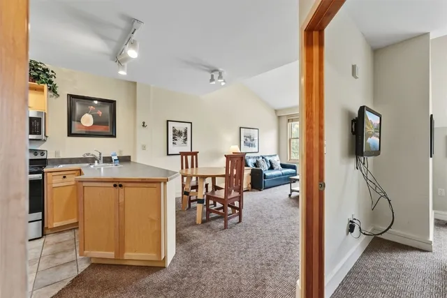 a view of a kitchen with appliances and furniture