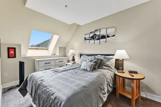 a bedroom with a bed and a lamp