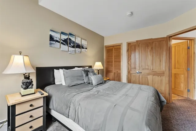 a bedroom with a bed and dressers