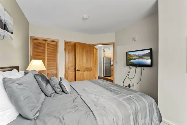 a bedroom with a bed and a flat screen tv