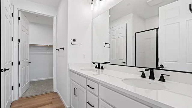 a bathroom with a double vanity sink and a mirror