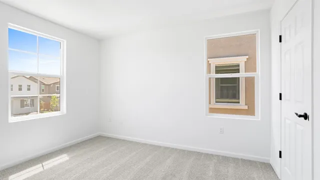 an empty room with windows and closet