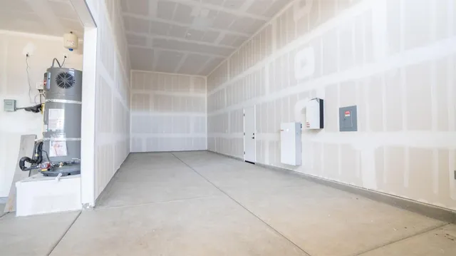 a view of a hallway with white walls and chandelier