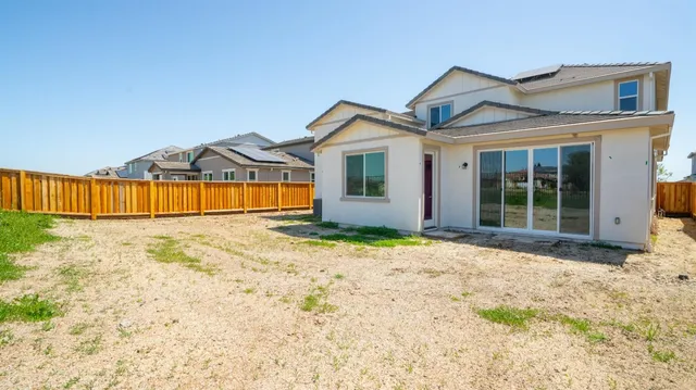 a view of a house with a wooden fence
