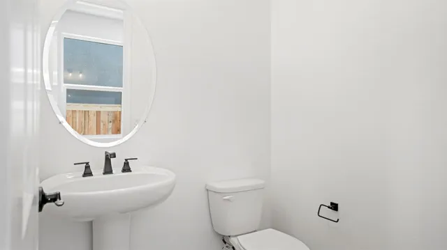 a bathroom with a sink a mirror and a toilet