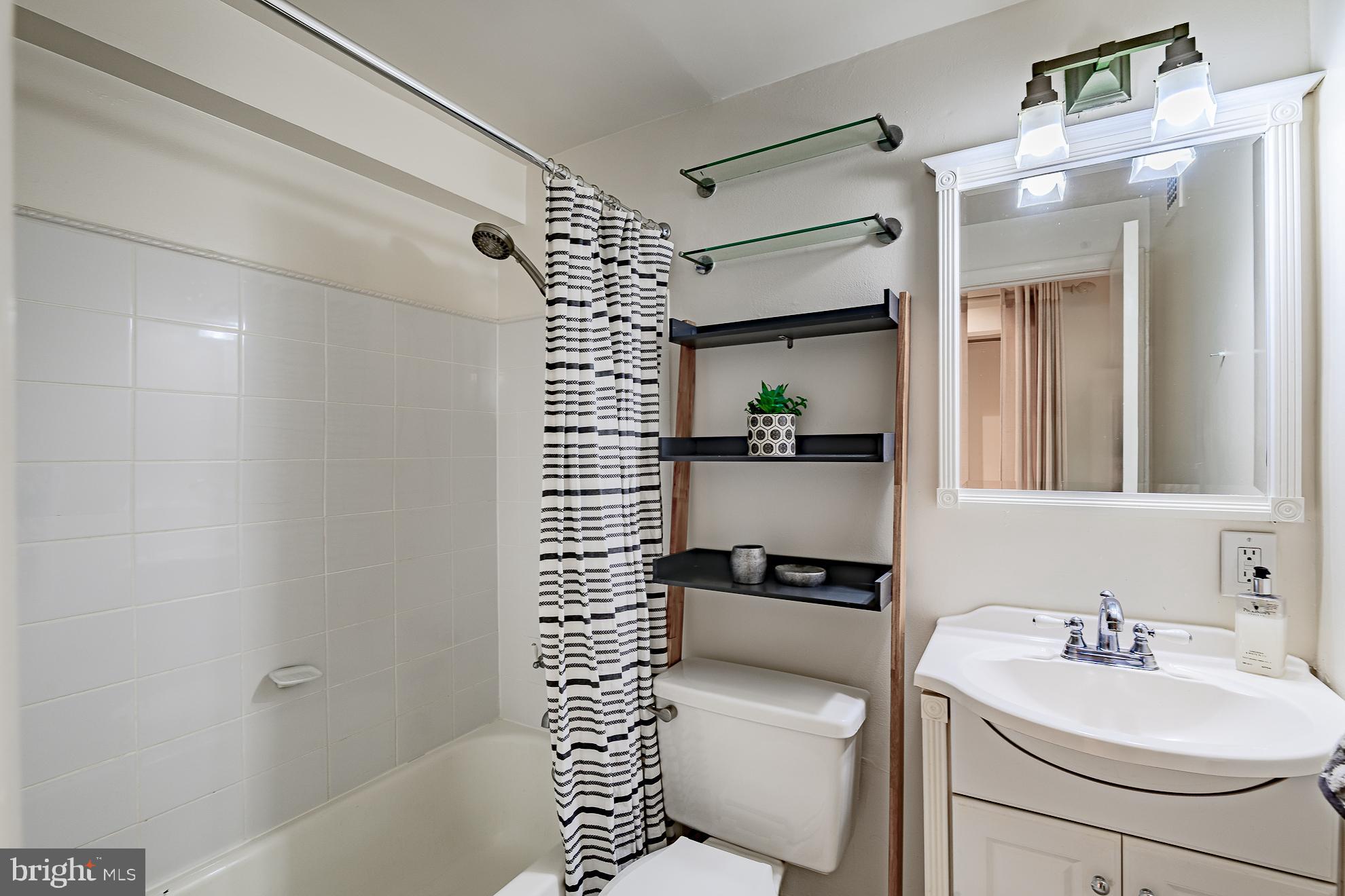 333 2nd Street Northeast, Unit 206 Washington, DC 20002 - Photo 14 of 19 a bathroom with a sink toilet and shower