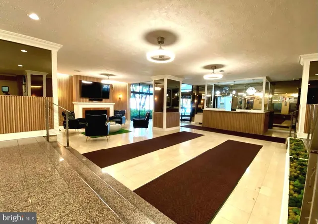 a large kitchen with kitchen island a counter top space and stainless steel appliances