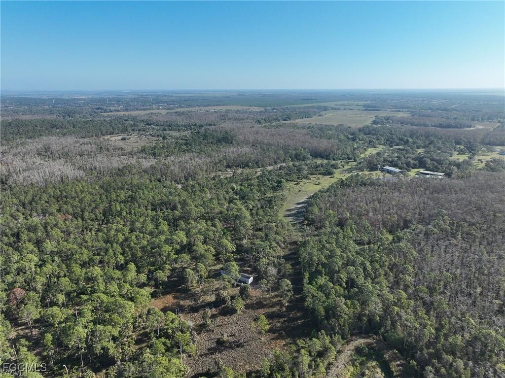 17800 Grand Chenier Road Fort Myers, FL 33913 - Photo 21 of 34 an aerial view of house with yard and mountain view in back