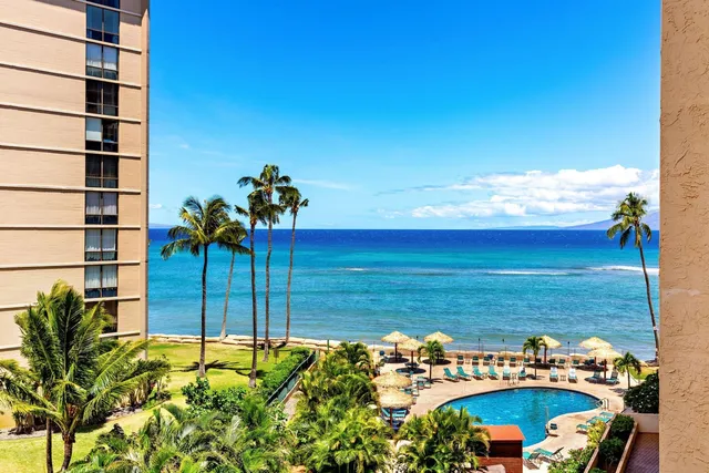 a view of a big yard with an ocean view