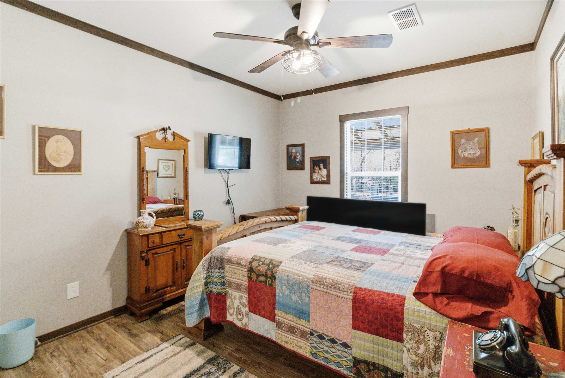 7921 Vista Ranch Road Smithville, TX 78957 - Photo 18 of 39 A comforting bedroom features wood-look flooring and a prominent ceiling fan, creating a relaxing atmosphere.