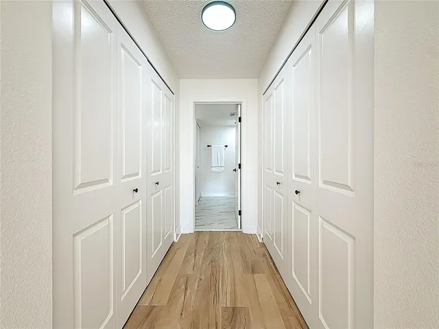 a view of hallway with wooden floor