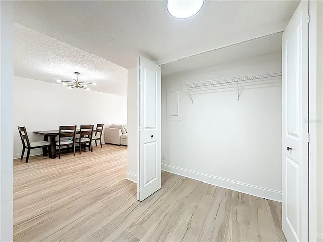 a view of a livingroom with chairs and wooden floor