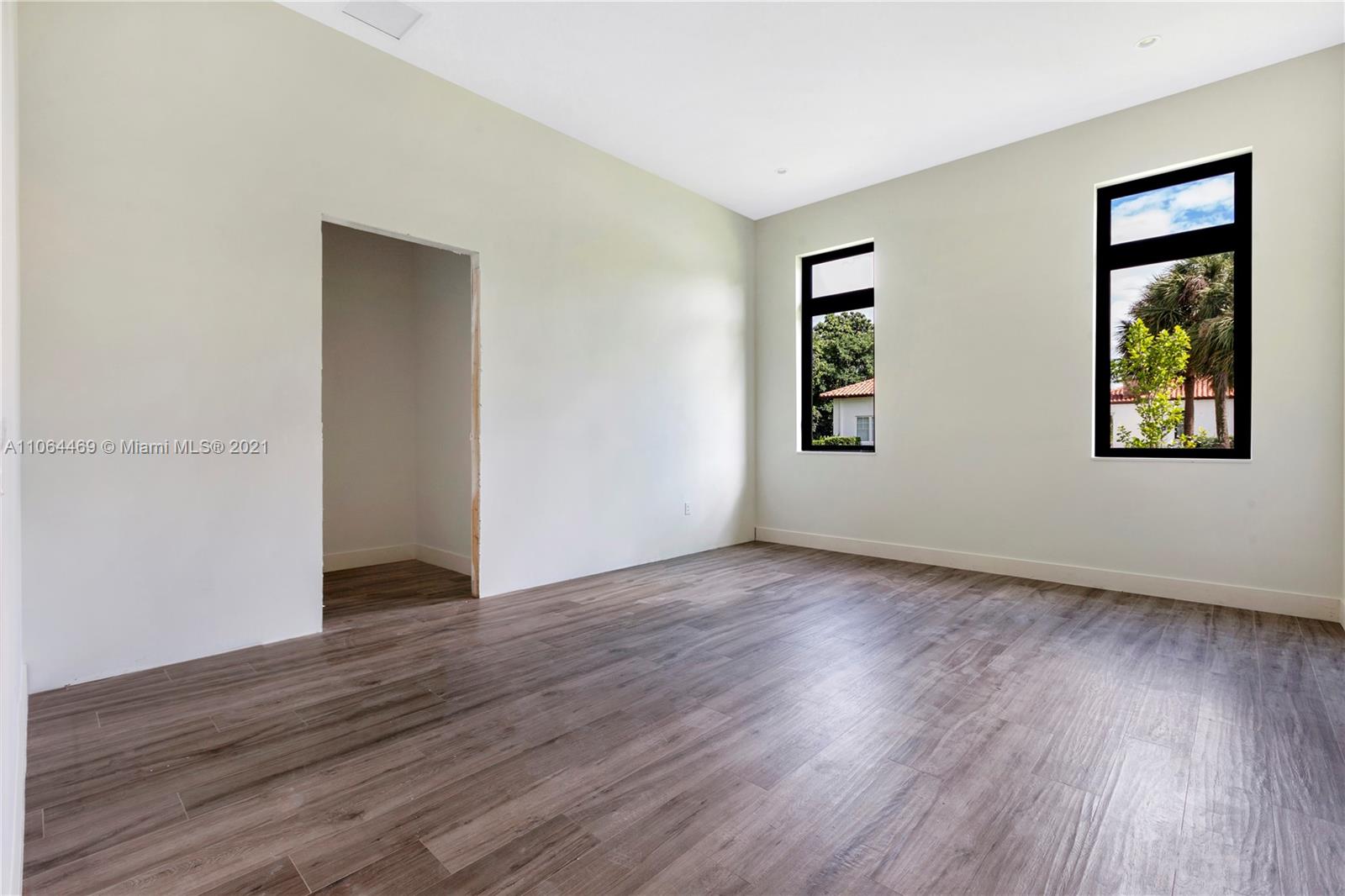 12701 Stirling Road Southwest Ranches, FL 33330 - Photo 23 of 38 a view of an empty room with wooden floor and a window
