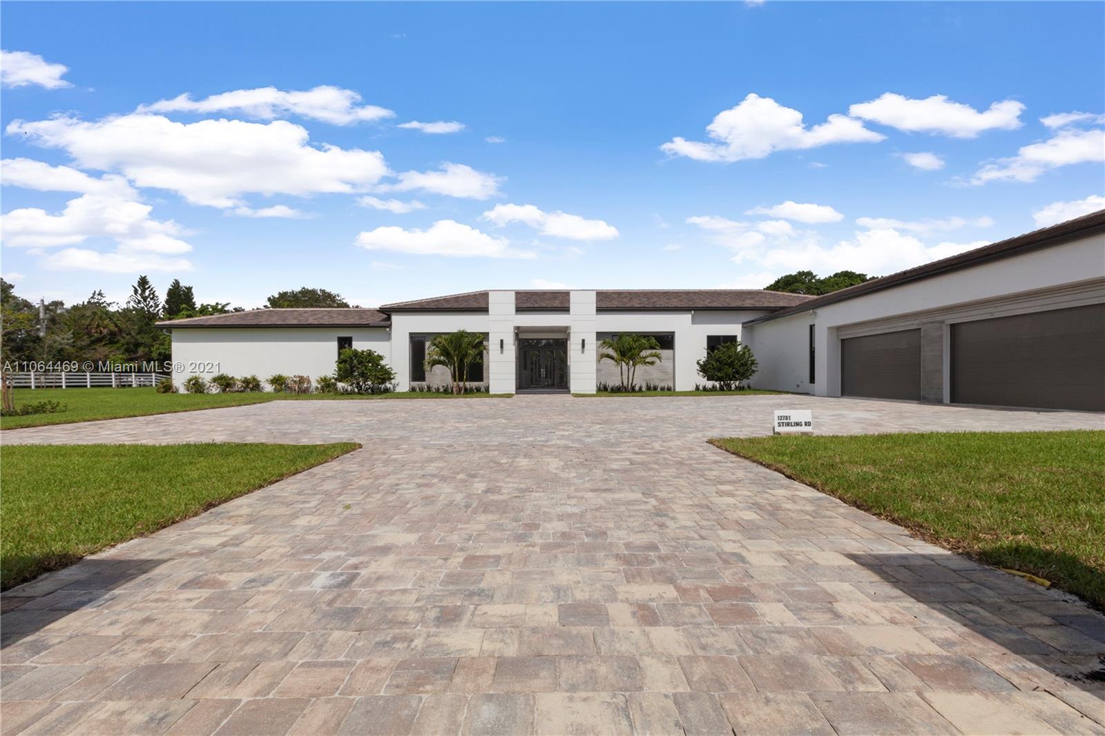 12701 Stirling Road Southwest Ranches, FL 33330 - Photo 5 of 38 a view of house with yard and entertaining space