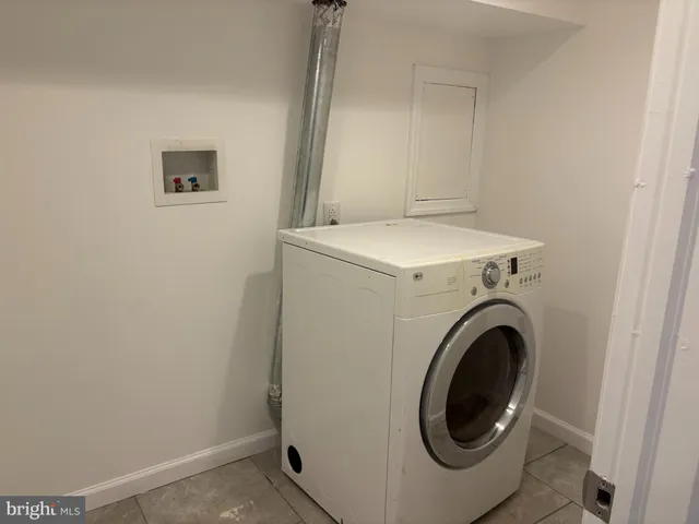 a bathroom with a bath tub with a shower