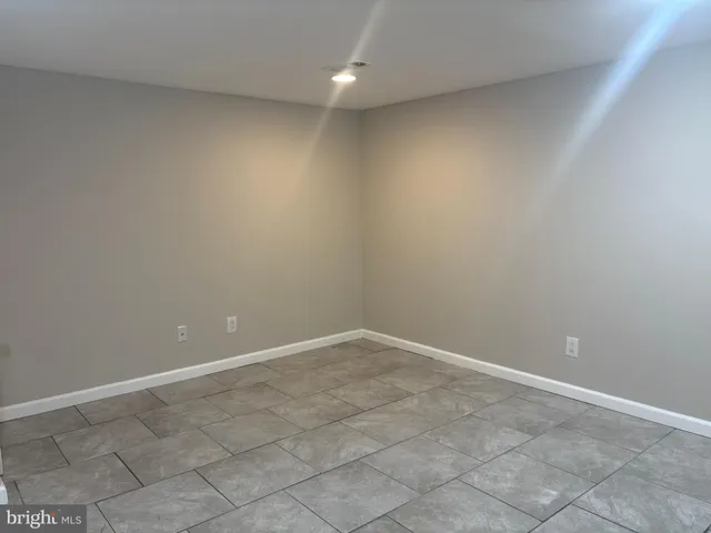 a kitchen with a refrigerator and a stove top oven