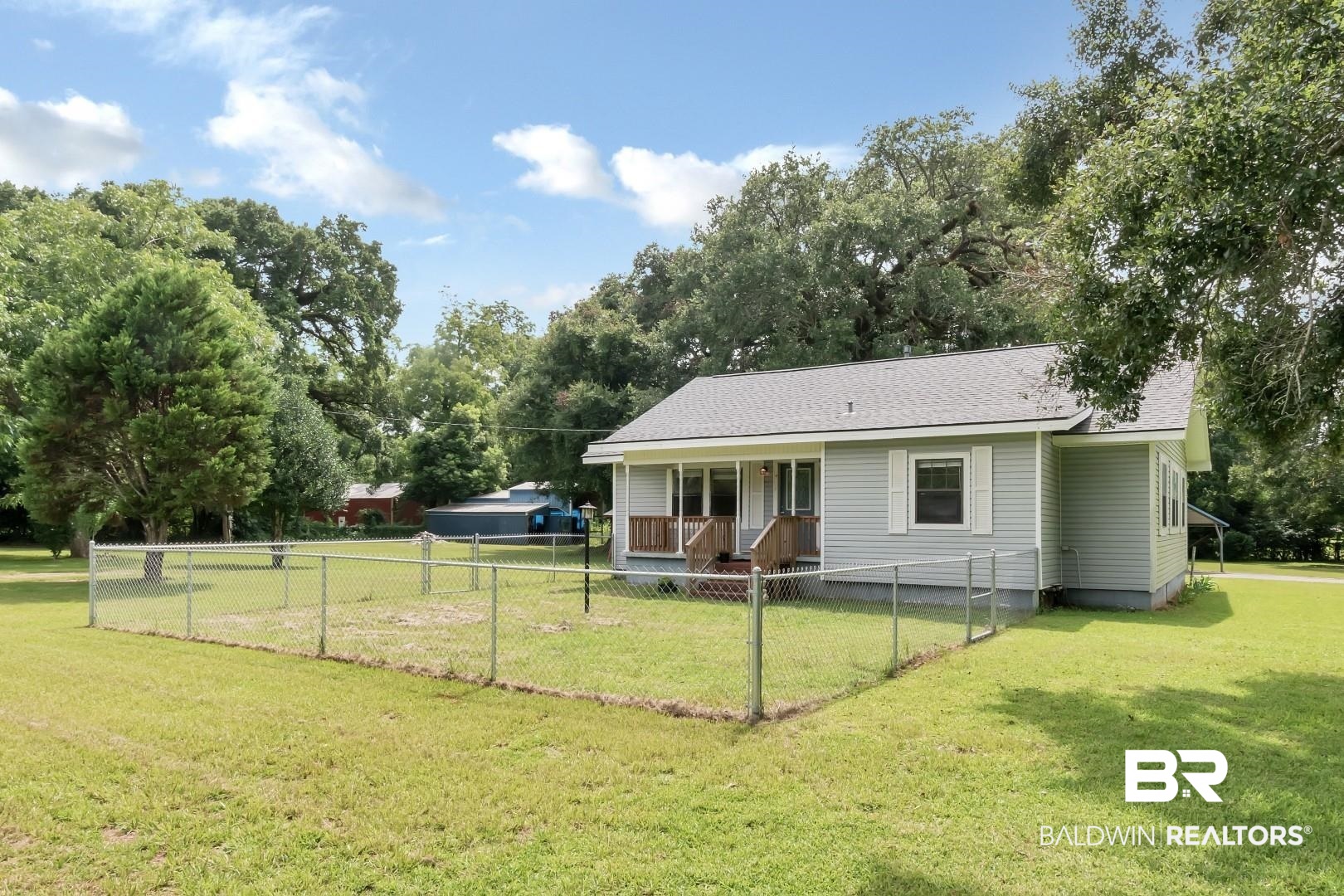 12751 Zanzibar Road Grand Bay, AL 36541 - Photo 2 of 30 Rear view of house with a porch and a yard