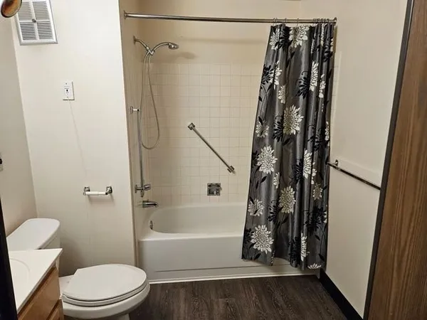 a bathroom with a toilet and a shower
