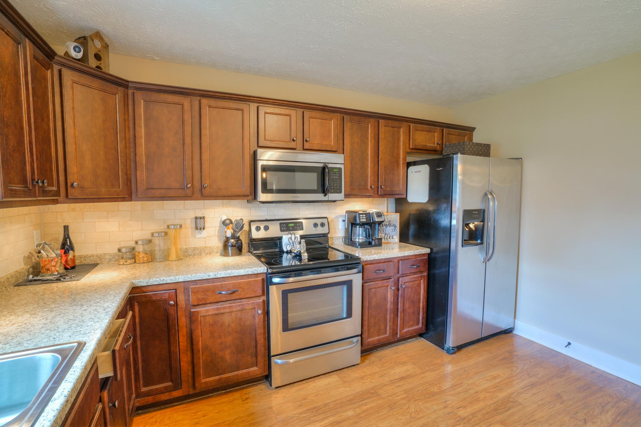 5051 Epps Mill Road Christiana, TN 37037 - Photo 8 of 26 Stainless appliances, granite countertops & tile backsplash.