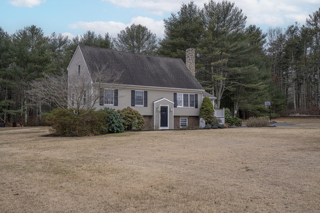 113 Pierce Street Rochester, MA 02770 - Photo 2 of 40 a front view of house with yard and trees in the background