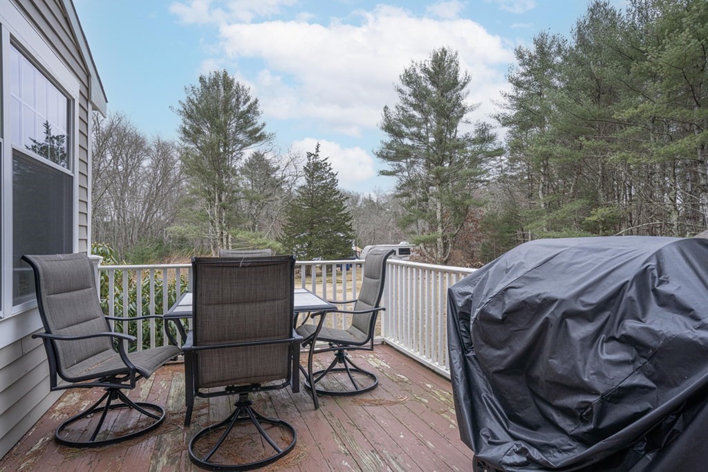 113 Pierce Street Rochester, MA 02770 - Photo 8 of 40 a view of a patio with table and chairs with wooden floor and fence