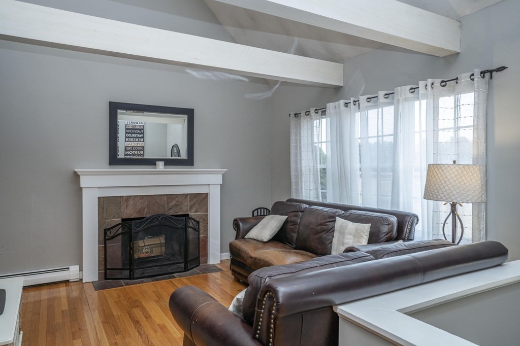 113 Pierce Street Rochester, MA 02770 - Photo 10 of 40 a living room with furniture and a fireplace