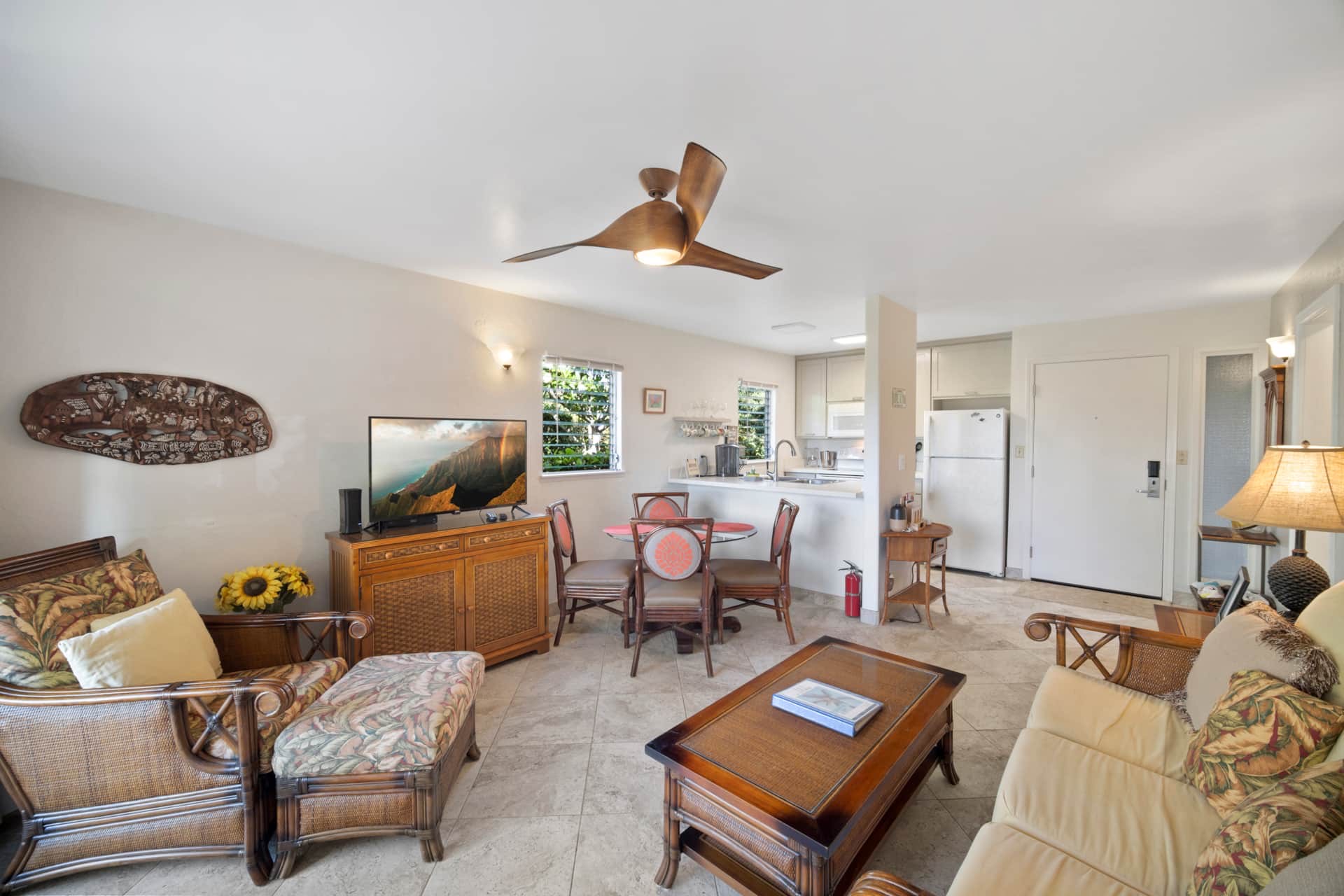 525 Aleka Loop, Unit K8 Kapaa, HI 96746 - Photo 4 of 13 a living room with furniture a flat screen tv and a table