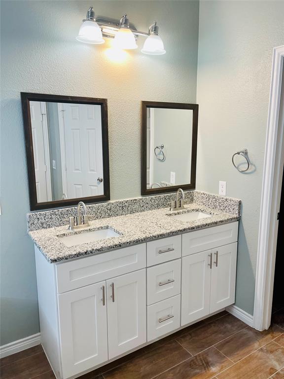 548 Kerry Street Crowley, TX 76036 - Photo 21 of 35 a bathroom with a granite countertop sink and a mirror