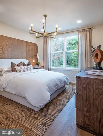 a spacious bedroom with a bed and a chandelier