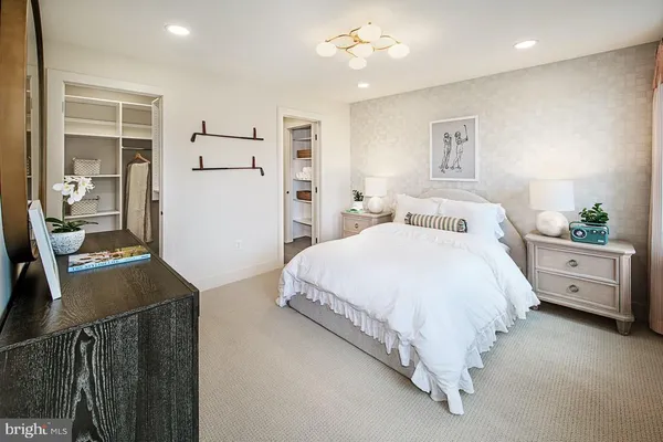 a bedroom with a bed and a potted plant