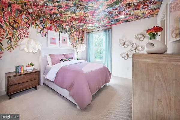 a bedroom with a large bed and a flat tv screen