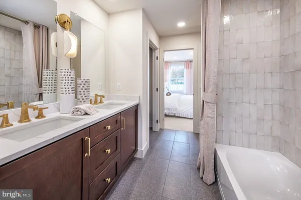 a bathroom with a toilet a sink a mirror and shower