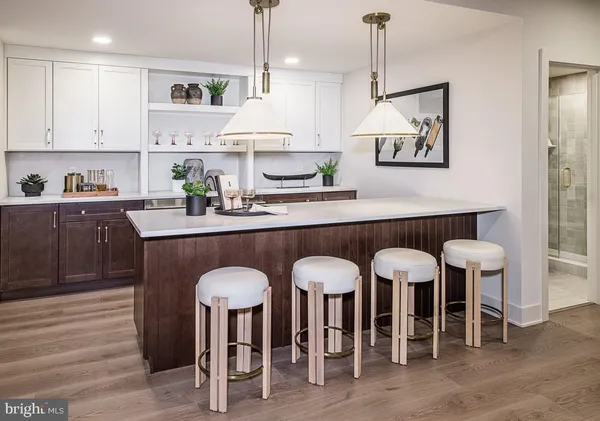 a kitchen with stainless steel appliances granite countertop a table chairs sink and cabinets