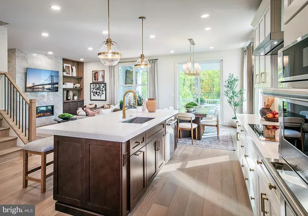 a kitchen with stainless steel appliances granite countertop a stove and a large window
