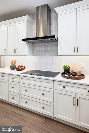 a dining hall with stainless steel appliances granite countertop a table chairs stove and kitchen view