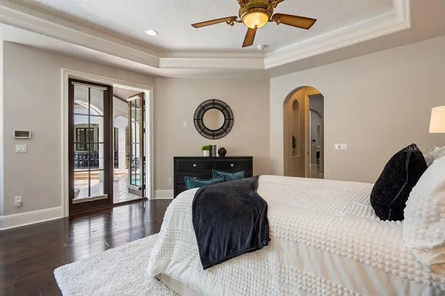 a living room with furniture a flat screen tv and a large window