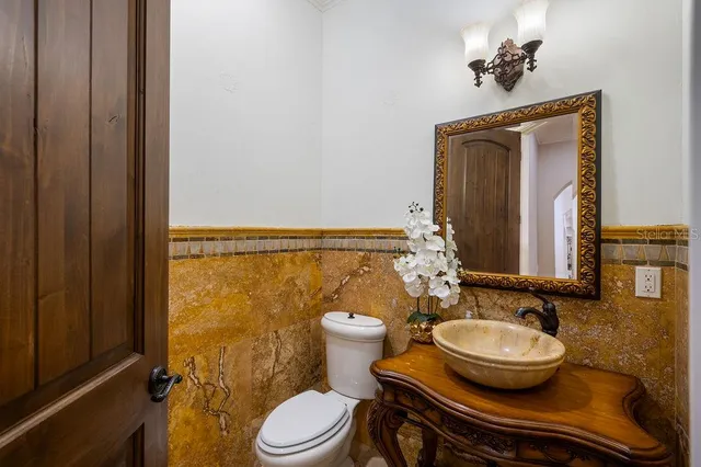 a room with pool table and ceiling fan