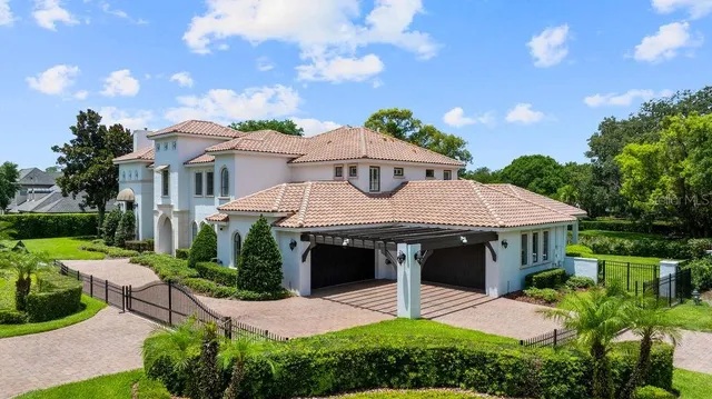 an aerial view of a house with a yard and outdoor space