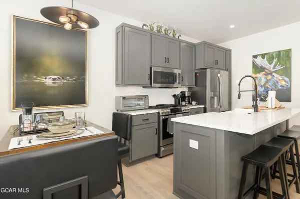 a kitchen with a sink stove and refrigerator