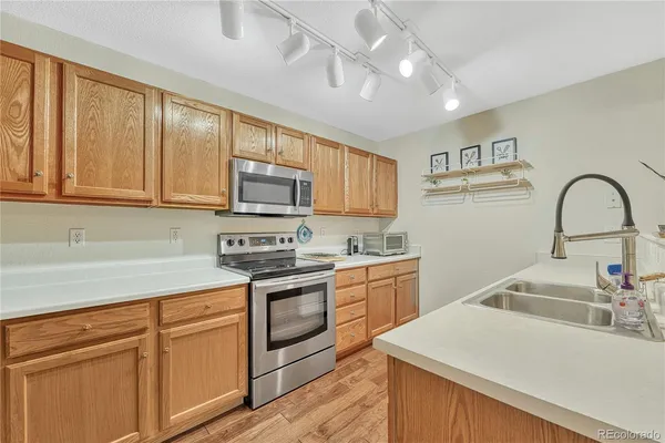 a kitchen with a sink cabinets and appliances