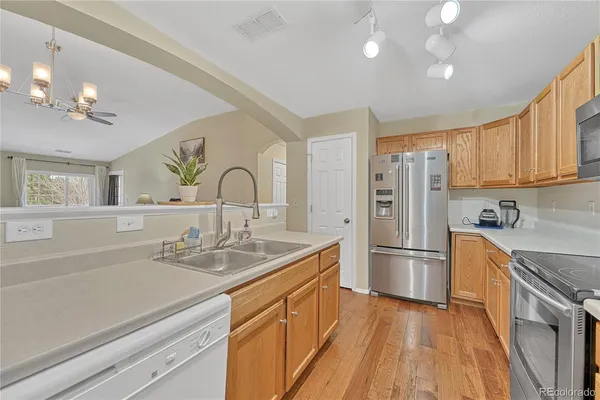 a kitchen with refrigerator cabinets and a sink