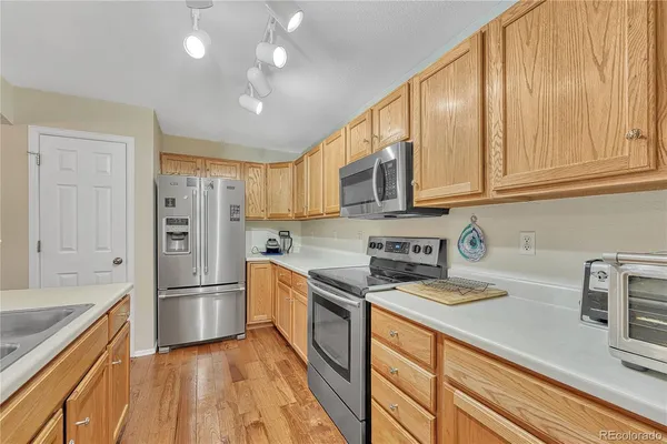 a kitchen with stainless steel appliances granite countertop a refrigerator sink and cabinets