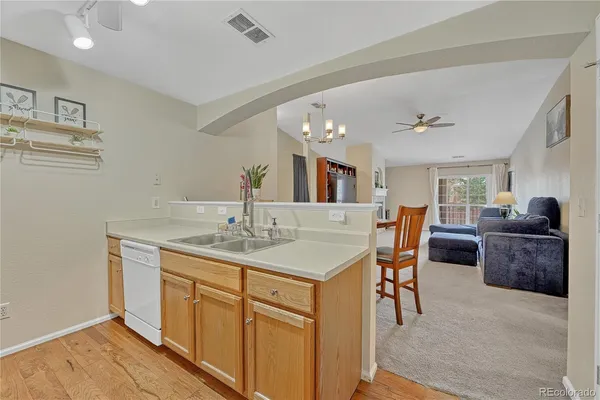 a living room with furniture a dining table and kitchen view